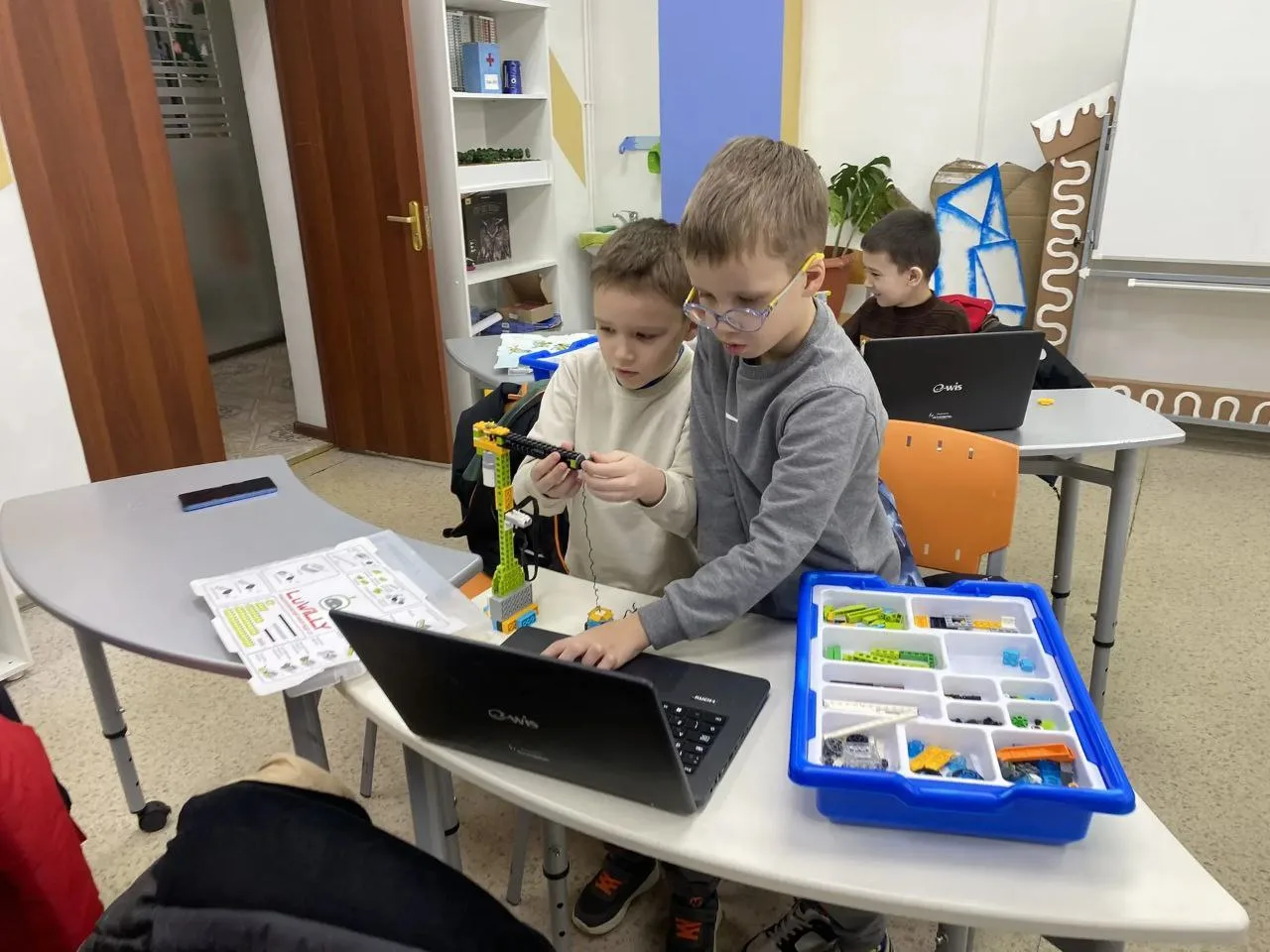 Дети работают с конструктором LEGO в клубе Роббург